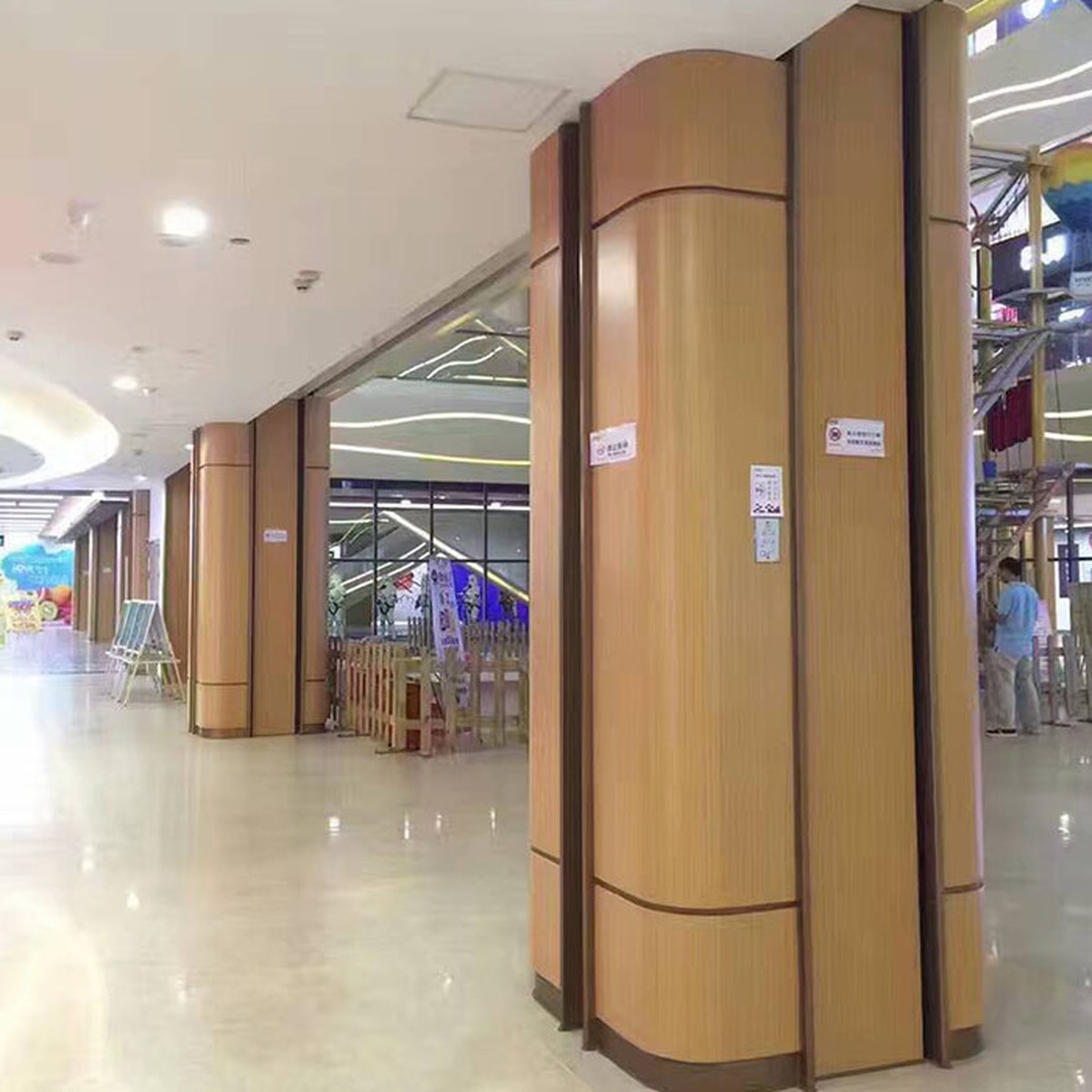 A row of bronze-toned column enclosures in a lobby