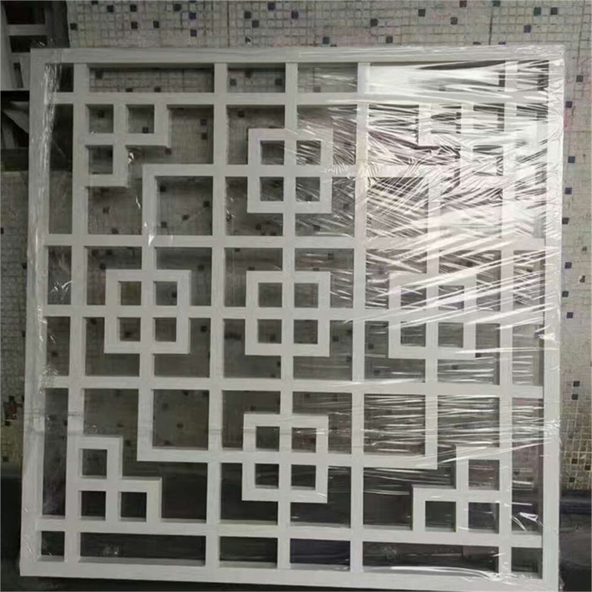 White square-pattern grille panel with an outer frame and protective wrapping